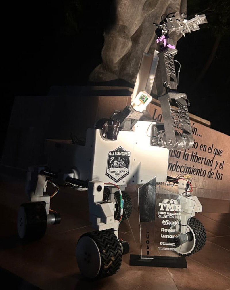 Detalle del rover: brazo robótico articulado, chasis blanco, suspensión, ruedas y cableado electrónico